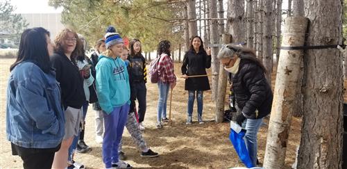 Nookomis Teaching Students How to Tap Trees 